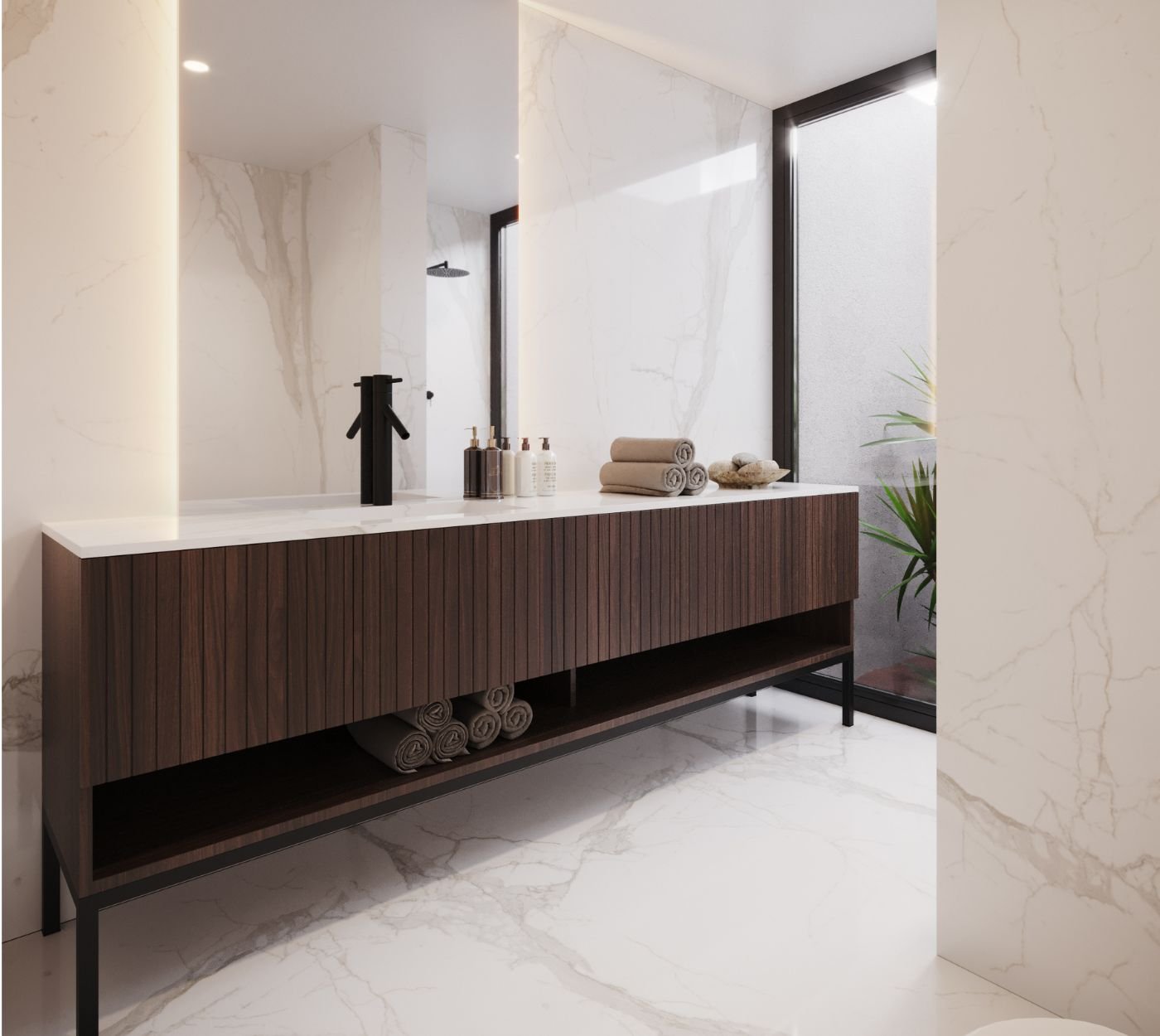 Um projeto de interior design que reflete a sofisticação das casas de banho modernas, conjugando mármore claro com nobres móveis de casa de banho.