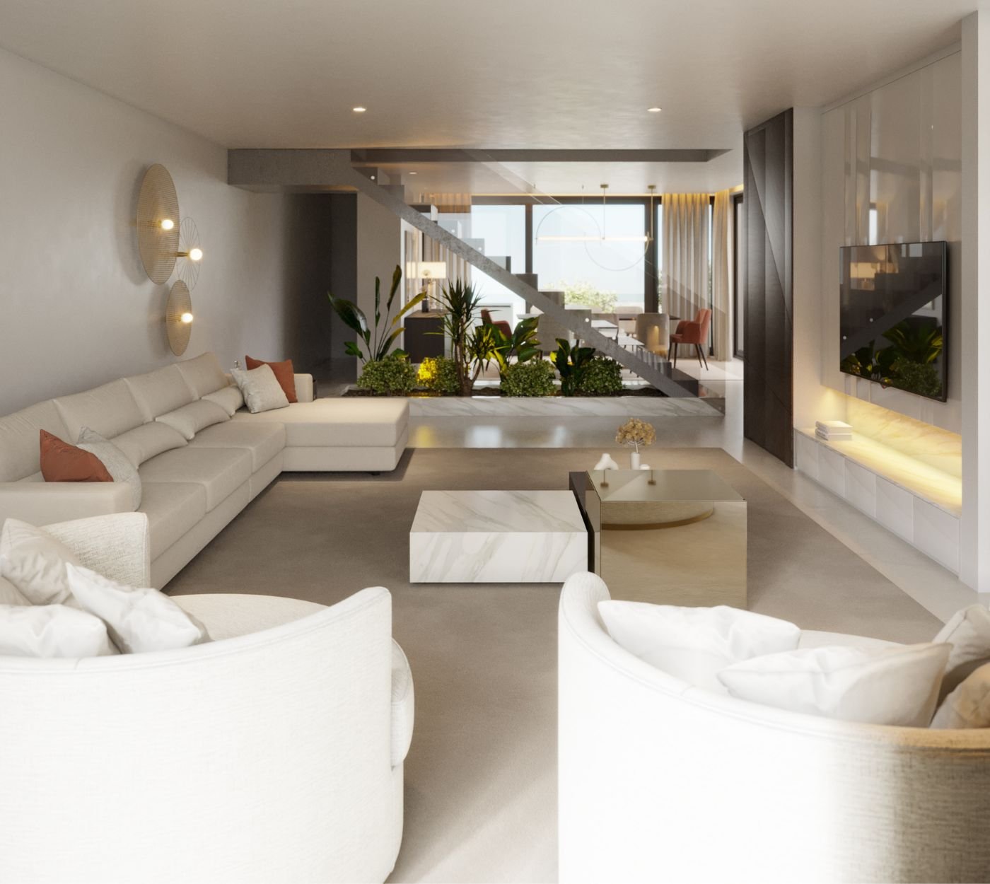 Um grande open space integrado com uma escada ao fundo e plantas, revelando uma ampla sala de estar moderna com confortáveis poltronas claras e um sofá chaise longue em tons neutros.
