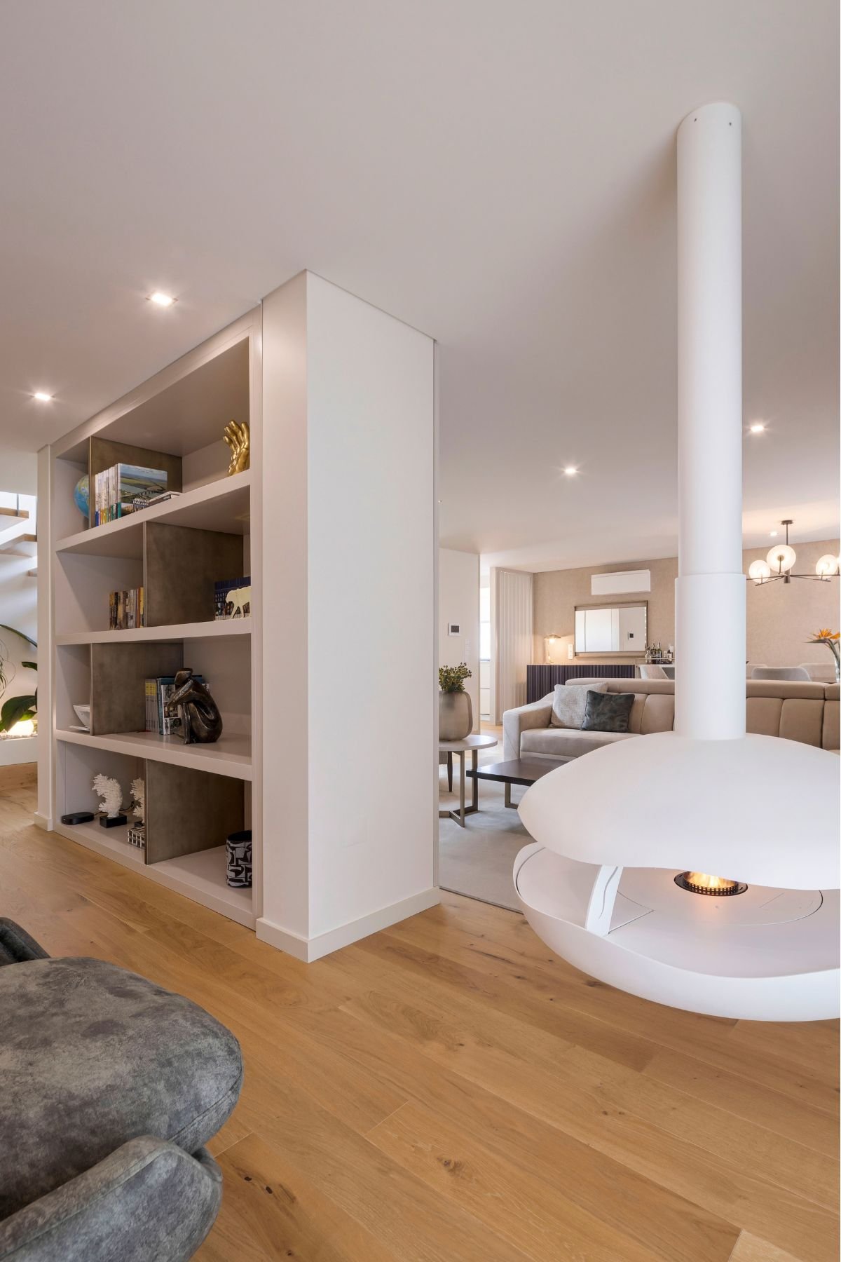 Lareira suspensa de design e estante divisória aberta integrando ambientes em open space, ícone de arquitetura, interior design e decoração em casas de luxo.